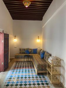 a living room with a couch and a table at Riad La Mentha Panoramic Terrace in Fes Medina in Fez