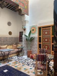 a living room with a couch and a table at Riad La Mentha Panoramic Terrace in Fes Medina in Fez