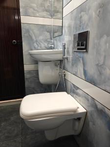 a bathroom with a toilet and a sink at Aman Residency in Thodupuzha
