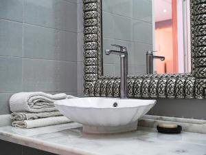a bathroom with a white sink and a mirror at Agréable suite situé dans une villa in Rabat +18 photos