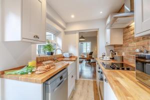 a kitchen with white cabinets and wooden counter tops at 1 Bed in Middlesbrough oc-79273 in Great Ayton +13 photos