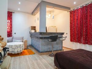 a bedroom with a bed and a bar in it at Agréable suite situé dans une villa in Rabat