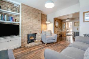 a living room with a fireplace and a tv at 1 Bed in Middlesbrough oc-79273 in Great Ayton