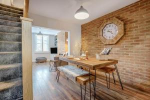 a dining room with a brick wall and a clock at 1 Bed in Middlesbrough oc-79273 in Great Ayton