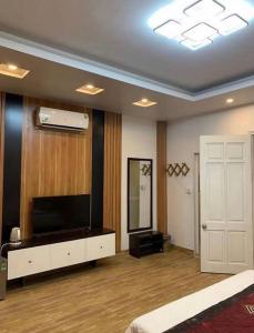 a living room with a television and a mirror at G9 Home hotel in Hanoi