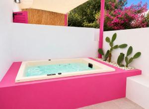 a hot tub in a pink box with a cactus at Anchorage Paros Boutique & Private Beach in Piso Livadi +60 photos