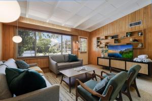 a living room with a couch and a table at Bos Beach Bungalow in Anna Maria