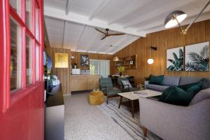 a living room with a couch and a table at Bos Beach Bungalow in Anna Maria