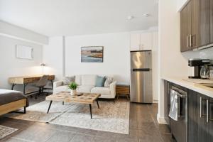 a kitchen and living room with a couch and a table at Great Located Studio perfect for 2 with parking in Toronto