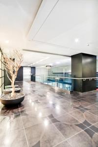 a large lobby with a potted tree in the middle at Great Located Studio perfect for 2 with parking in Toronto