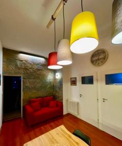 a living room with a red couch and lights at Apartmán Dobrá Naděje in Uherské Hradiště