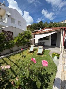 a garden with two chairs and a patio at Olive tree villa in Ligia