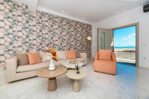 a living room with a couch and two chairs at Marvel Suite in Imerovigli