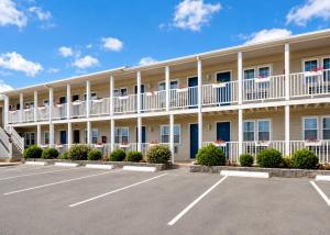 an exterior view of a hotel with a parking lot at Pier 7 Condominium Resort in Yarmouth +10 photos