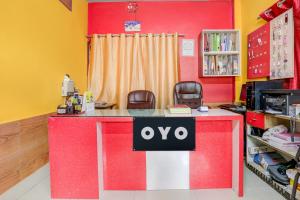 a red and white counter in a room with chairs at Hotel O Kings Hotel & Banquet in Siliguri