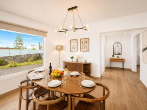 a dining room with a table and chairs and a window at Villa Yaiza Secret 1 in Yaiza