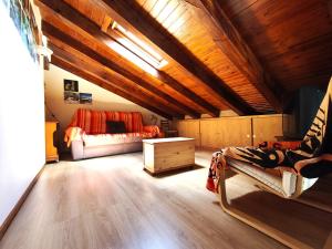 a attic room with a bed and a couch at AC Apartaments Solana Ransol in Ransol
