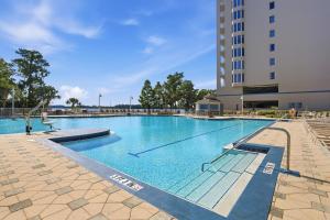 a large swimming pool in front of a building at Disney Lakefront Luxury! in Orlando