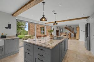 a large kitchen with a large island in the middle at 4 Bed in Taunton oc-w35167 in West Monkton