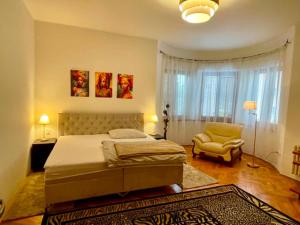 a bedroom with a bed and a chair at Apartmán Dobrá Naděje in Uherské Hradiště