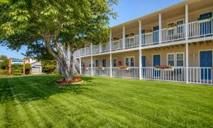 a large apartment building with a green yard at Pier 7 Condominium Resort in Yarmouth