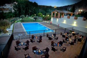a view of a swimming pool with chairs and a table at HS Olivos in Alcalá del Júcar
