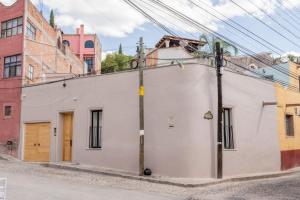 a white building on the side of a street at Patio 7 Studios in San Miguel de Allende