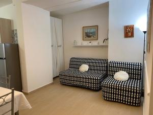 a living room with a couch and two chairs at Villa Paradiso in Gaeta