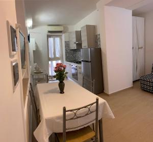 a kitchen with a table with a vase of flowers on it at Villa Paradiso in Gaeta