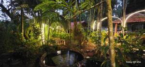 a garden with a bath tub in the middle of trees at Twin Retreat in Madikeri