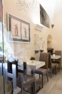 a dining room with two tables and chairs at Antica Dimora Magi in Sorrento
