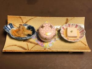 a wooden tray with three bowls of food on it at IZUNA INN & SPA - the veggie delights in Ito