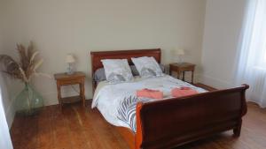 a bedroom with a bed with two pillows on it at Au petit moulin in Issigeac
