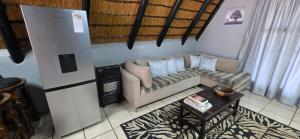 a living room with a couch and a table at Eagles Nest in Rustenburg