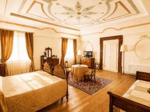 a room with two beds and a table in it at Hotel Villa Cornér della Regina - Buongiorno! Hotels in Vedelago