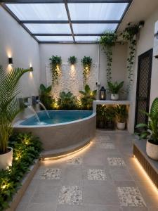 a hot tub in a room with plants and lights at Bali-Inspired Pool Haus Cebu in Lapu Lapu City