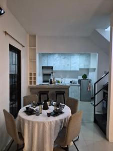 a table in a kitchen with a table cloth on it at Bali-Inspired Pool Haus Cebu in Lapu Lapu City