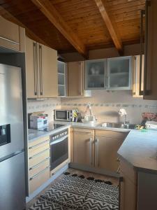 a kitchen with a sink and a refrigerator at K-Loft Urban Athens in Pallini
