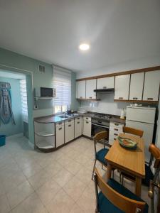 a kitchen with a table and a dining room at Casa de la bis in A Guarda