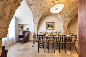 a dining room with a table and chairs at Terra Sessana Ville e Trullo con piscina privata in Ostuni