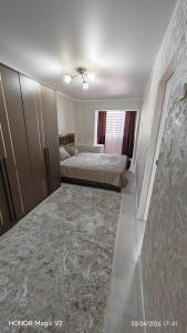 a bedroom with two beds and a large marble floor at Aktau 4-31 in Aktau +3 photos