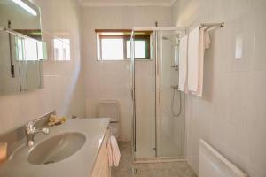 a white bathroom with a sink and a shower at Step by Step Atlantic Guesthouse in Vila do Conde +22 photos