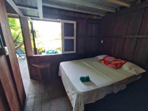 a small bed in a room with a window at Casa Origen in El Valle