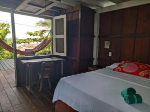 a bedroom with a bed and a desk and a window at Casa Origen in El Valle
