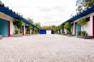 an empty courtyard of a school with blue and white buildings at Lemonte Motel in Brusque
