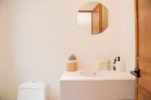 a bathroom with a white sink and a mirror at Patio 7 Studios in San Miguel de Allende +91 photos