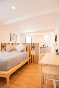 a bedroom with a bed and a table at Patio 7 Studios in San Miguel de Allende