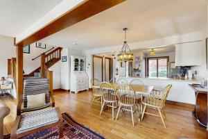 a kitchen and dining room with a table and chairs at Saltbox 12B in White River Junction