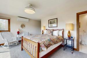 a bedroom with a bed and a bathroom at Saltbox 12B in White River Junction