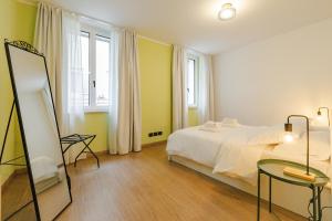 a bedroom with a bed and a table and a mirror at NEW Tocai – in via Rastello per 4 pp in Gorizia